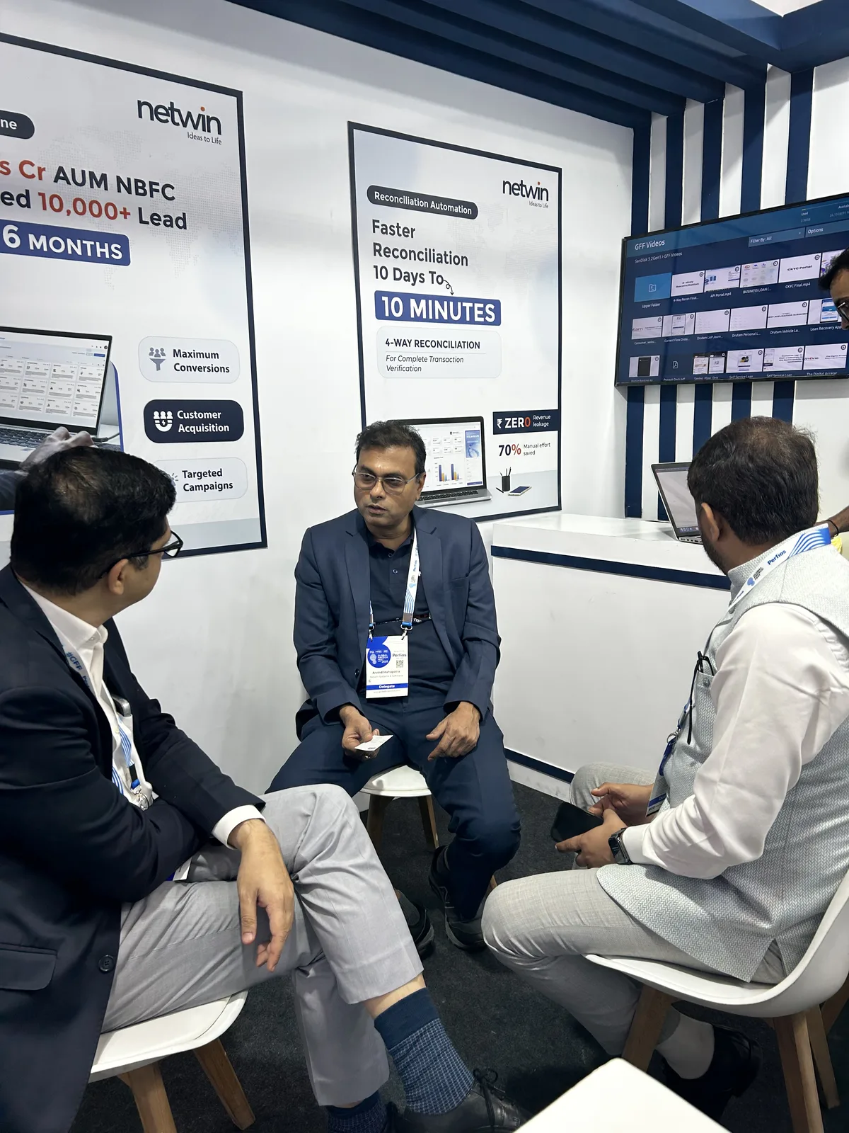 Netwin team reviewing GFF session recordings on screen at the booth