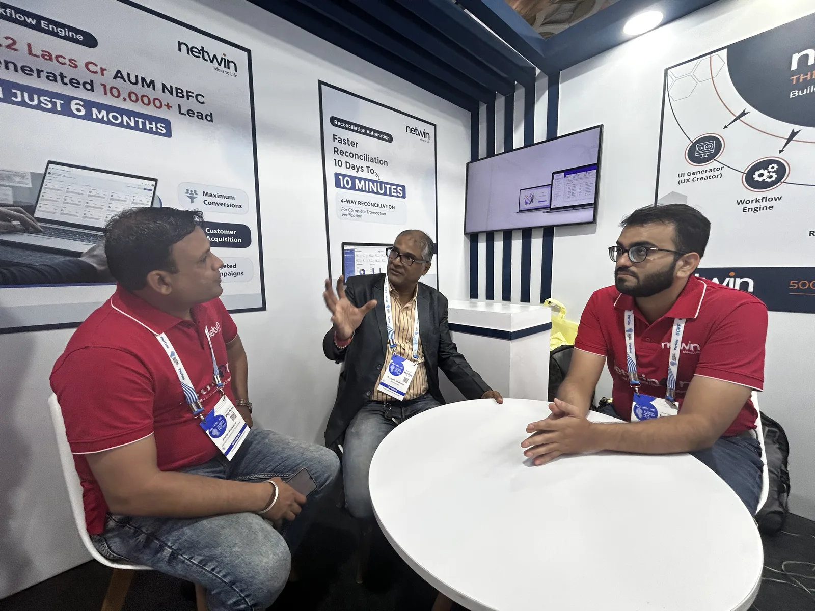 Netwin team discussing the Workflow Engine and reconciliation automation displays